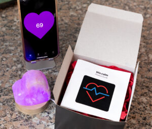 image of a mobile device displaying the bio.calm app heart beat tool at 2-levels below baseline (purple). 